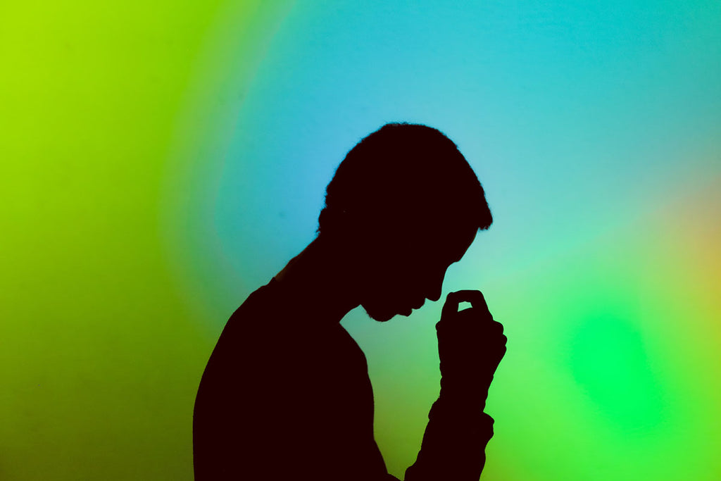 Silhouette of a man looking stressed