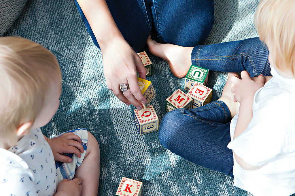 Mother playing with children using blocks